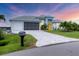 Beautiful single-Gathering home features a well-manicured lawn, paver driveway, and a two-car garage at 10079 Lebanon Dr, Port Charlotte, FL 33981