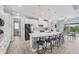 Bright kitchen features an island with seating, stainless steel appliances, and an adjacent dining area at 10079 Lebanon Dr, Port Charlotte, FL 33981