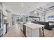 Open kitchen featuring stone countertops, an island with seating, and views of the living area at 10079 Lebanon Dr, Port Charlotte, FL 33981