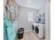 Well-equipped laundry room with modern washer and dryer units at 10079 Lebanon Dr, Port Charlotte, FL 33981