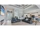 Open-concept living room with lots of natural light, tile flooring, and a partial view of the kitchen at 10079 Lebanon Dr, Port Charlotte, FL 33981