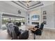 Open-concept living room features a stone accent wall with fireplace, and sliding glass doors to the patio at 10079 Lebanon Dr, Port Charlotte, FL 33981