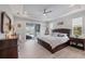 Spacious primary bedroom suite with tray ceilings and sliding glass doors to the lanai at 10079 Lebanon Dr, Port Charlotte, FL 33981