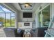 Outdoor patio features a fireplace, wet bar and comfortable seating at 10079 Lebanon Dr, Port Charlotte, FL 33981