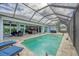 Backyard pool area with screen enclosure and covered patio at 10079 Lebanon Dr, Port Charlotte, FL 33981
