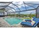 Sparkling pool with screened enclosure and comfortable lounge chairs at 10079 Lebanon Dr, Port Charlotte, FL 33981