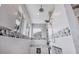 Elegant walk-in shower with built-in niches, decorative tile accents, and rainfall shower head at 10079 Lebanon Dr, Port Charlotte, FL 33981
