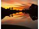 Picturesque waterfront at dusk with a sunset reflecting on the water at 10079 Lebanon Dr, Port Charlotte, FL 33981