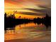 Picturesque waterfront at dusk with a sunset reflecting on the water at 10079 Lebanon Dr, Port Charlotte, FL 33981