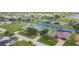 Scenic aerial view of waterfront homes along a canal, showcasing lush landscaping and community golf course nearby at 104 Mark Twain Ln, Rotonda West, FL 33947