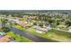 Residential aerial of a canal-front community with well-kept lawns and screened lanais, offering a serene and desirable setting at 104 Mark Twain Ln, Rotonda West, FL 33947