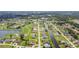 Residential aerial of canal-lined neighborhood near golf course, showing community layout and access to recreational amenities at 104 Mark Twain Ln, Rotonda West, FL 33947