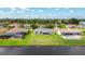 Spacious backyard with a well-kept lawn and a screened lanai, offering serene water views and a great outdoor living space at 104 Mark Twain Ln, Rotonda West, FL 33947