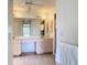 Spacious bathroom featuring tiled floors, a long vanity and a walk-in shower at 104 Mark Twain Ln, Rotonda West, FL 33947
