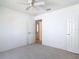 Carpeted bedroom with ceiling fan and access to rooms provides comfortable living space at 104 Mark Twain Ln, Rotonda West, FL 33947