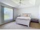 Bright bedroom with a tray ceiling, ceiling fan and large window overlooking the yard at 104 Mark Twain Ln, Rotonda West, FL 33947
