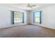 Bright bedroom with carpet, fan, and windows provides comfortable living space at 104 Mark Twain Ln, Rotonda West, FL 33947