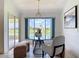 Cozy dining area with a glass-top table, stylish chairs, and a large window overlooking the water at 104 Mark Twain Ln, Rotonda West, FL 33947