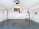 Spacious garage featuring a water heater, utility sink, and ample room for parking and storage at 104 Mark Twain Ln, Rotonda West, FL 33947