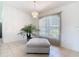 Bright living space featuring tile flooring, a modern chandelier, and a large window providing natural light at 104 Mark Twain Ln, Rotonda West, FL 33947