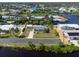Aerial view of waterfront property with lush landscaping, and canal access surrounded by other homes at 1060 Haste Ln, Englewood, FL 34223
