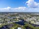 An aerial view of a quaint waterfront home nestled on a canal in a tranquil community at 1060 Haste Ln, Englewood, FL 34223