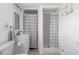 Bathroom featuring a modern sink and vanity, toilet, shower with curtain, and a second shower area at 1060 Haste Ln, Englewood, FL 34223