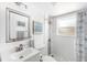 Updated bathroom featuring a vanity, toilet, and walk-in shower with a shower curtain and modern fixtures at 1060 Haste Ln, Englewood, FL 34223