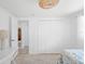 Bright bedroom with a single bed, white walls, tile floors, and a large closet at 1060 Haste Ln, Englewood, FL 34223