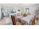 Open-concept kitchen and dining area featuring a dining table for six with an ornamental flower arrangement at 1060 Haste Ln, Englewood, FL 34223