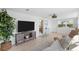 Bright living room features tile flooring, a cozy sofa, and natural light streaming through the windows at 1060 Haste Ln, Englewood, FL 34223