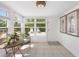 Bright sun room with multiple windows offers views of the outdoors and provides access to the outdoor area at 1060 Haste Ln, Englewood, FL 34223