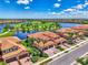 Beautiful aerial view showcasing the community's lush landscaping, lake, and golf course, with this property at 10788 Tarflower Dr # 201, Venice, FL 34293