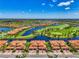 Aerial view showcasing the property's location with a lake and golf course, and neighborhood at 10788 Tarflower Dr # 201, Venice, FL 34293