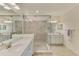 Modern bathroom with double vanity, marble countertops, and a glass-enclosed shower at 10788 Tarflower Dr # 201, Venice, FL 34293