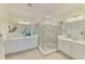 Bathroom featuring dual sinks, ample counter space, and a glass-enclosed shower at 10788 Tarflower Dr # 201, Venice, FL 34293
