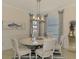Elegant dining room with a round table, stylish chandelier, and coastal-themed decor at 10788 Tarflower Dr # 201, Venice, FL 34293