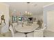 Open-concept dining area with a long table and decorative lighting, seamlessly connecting to the kitchen and living spaces at 10788 Tarflower Dr # 201, Venice, FL 34293