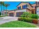 Charming two-story villa with a spacious driveway, lush landscaping, and well-maintained exterior at 10788 Tarflower Dr # 201, Venice, FL 34293