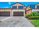 Charming Mediterranean-style home features lush landscaping, a brick driveway, and a welcoming facade at 10788 Tarflower Dr # 201, Venice, FL 34293