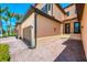 Well-maintained exterior features a brick driveway, stucco walls, and manicured landscaping for a welcoming entrance at 10788 Tarflower Dr # 201, Venice, FL 34293