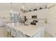 Modern kitchen with stainless appliances, white cabinets, and expansive island at 10788 Tarflower Dr # 201, Venice, FL 34293