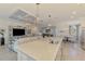 Kitchen features seating at the island, stainless appliances, and open floor plan at 10788 Tarflower Dr # 201, Venice, FL 34293