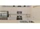 Well-lit kitchen featuring modern stainless appliances and a center island at 10788 Tarflower Dr # 201, Venice, FL 34293