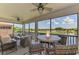 Inviting screened lanai with comfortable seating and a picturesque view of the lake and golf course at 10788 Tarflower Dr # 201, Venice, FL 34293