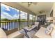 Relaxing screened lanai overlooking the lake and lush golf course, complete with comfortable outdoor seating at 10788 Tarflower Dr # 201, Venice, FL 34293