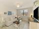 Bright living room featuring a neutral sofa, ceiling fan, window, and stylish decor, creating a comfortable atmosphere at 10788 Tarflower Dr # 201, Venice, FL 34293