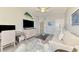 Open-concept living room with neutral sofa, ceiling fan, and stylish decor, creating a comfortable atmosphere at 10788 Tarflower Dr # 201, Venice, FL 34293