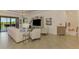 Airy living space featuring tile flooring, light-colored furniture, and seamless access to an outdoor patio area at 10788 Tarflower Dr # 201, Venice, FL 34293