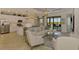Bright living space with modern white kitchen, stylish decor, and views of the outdoor scenery at 10788 Tarflower Dr # 201, Venice, FL 34293